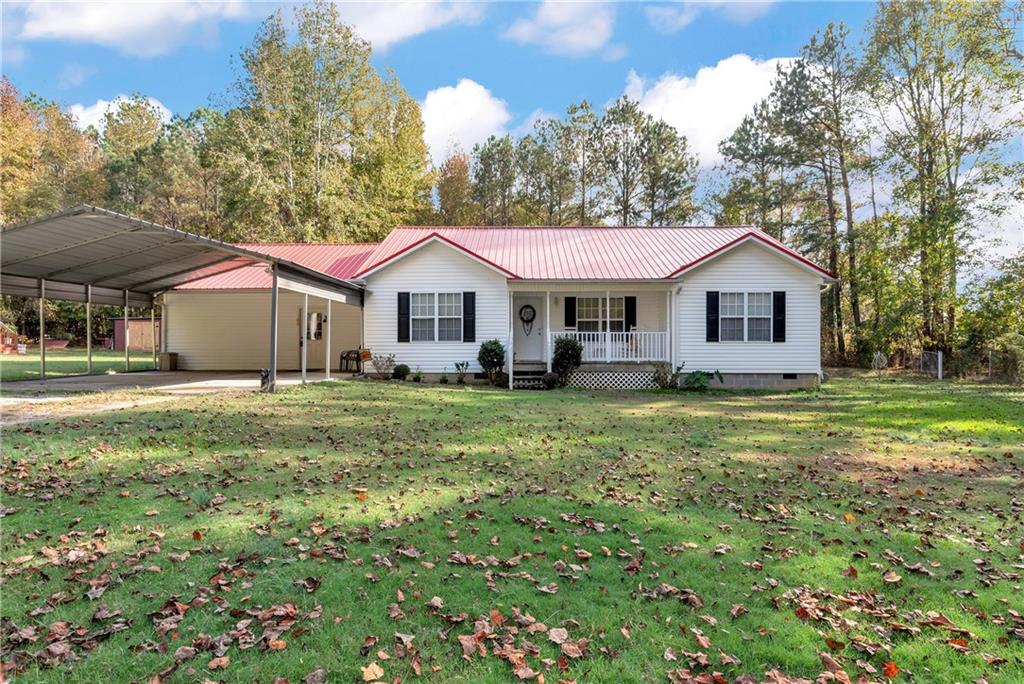 275 James Holcomb Road Hull, GA 30646 - Photo 1 of 1 a front view of a house with a garden and trees