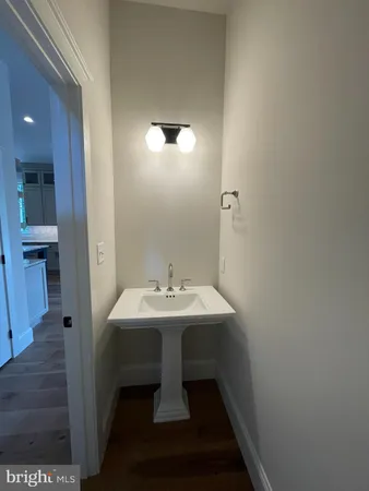 a view of a hallway with wooden floor and windows