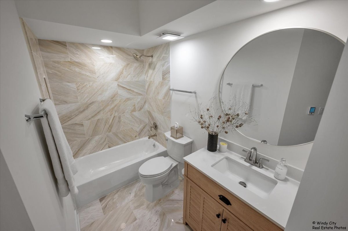 455 West Front Street, Unit 2208 Wheaton, IL 60187 - Photo 13 of 20 a bathroom with a sink mirror toilet and bathtub