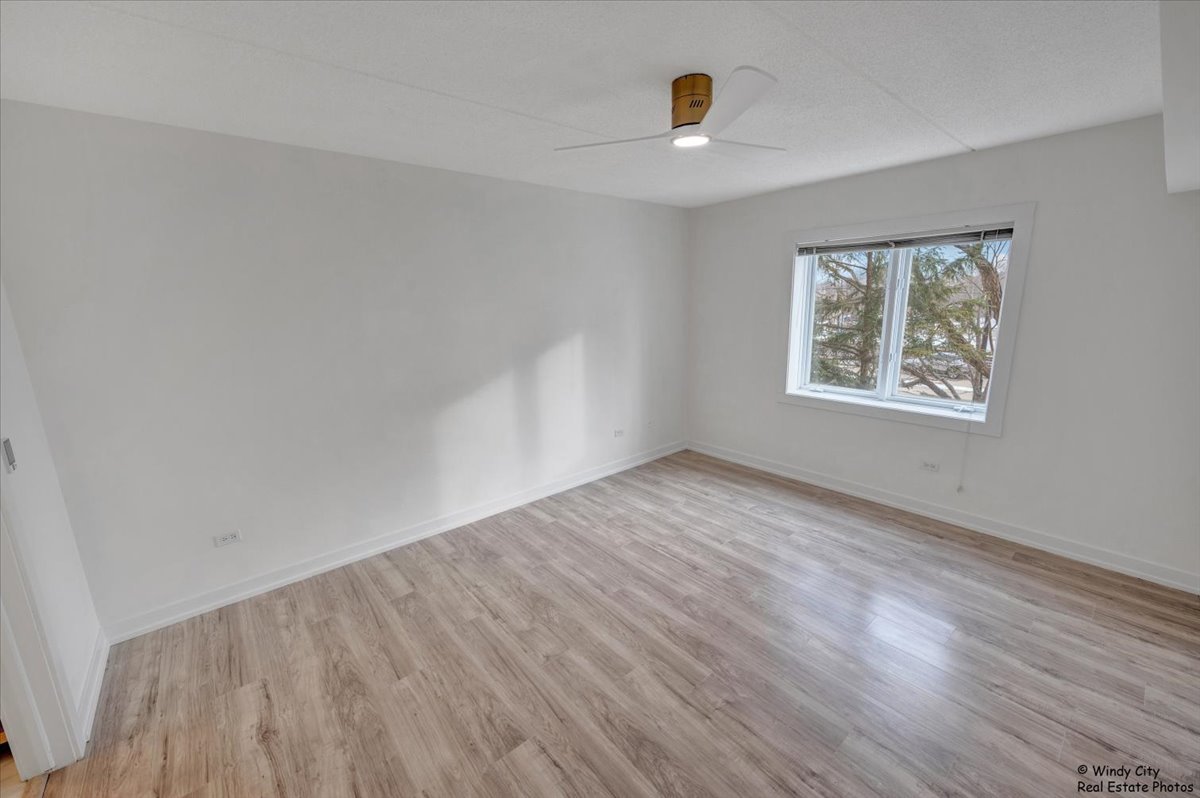 455 West Front Street, Unit 2208 Wheaton, IL 60187 - Photo 14 of 20 wooden floor in an empty room with a window