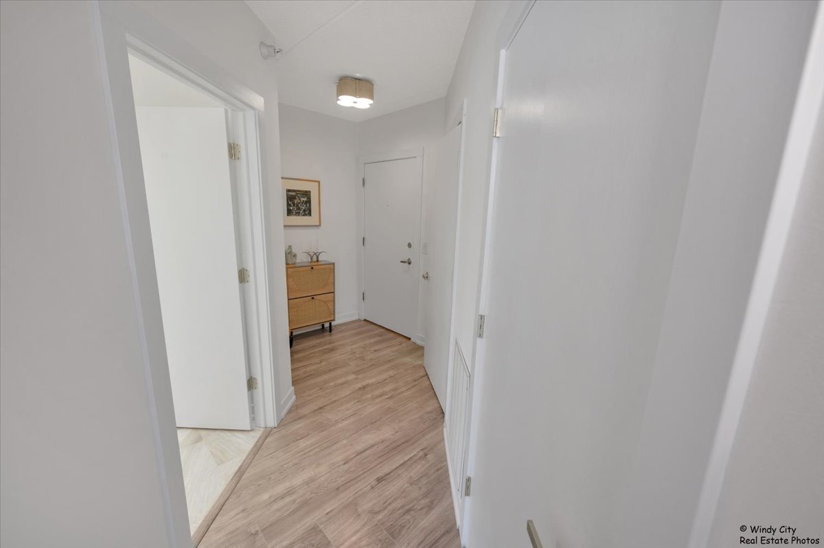 455 West Front Street, Unit 2208 Wheaton, IL 60187 - Photo 19 of 20 a view of a hallway with wooden floor and a bathroom