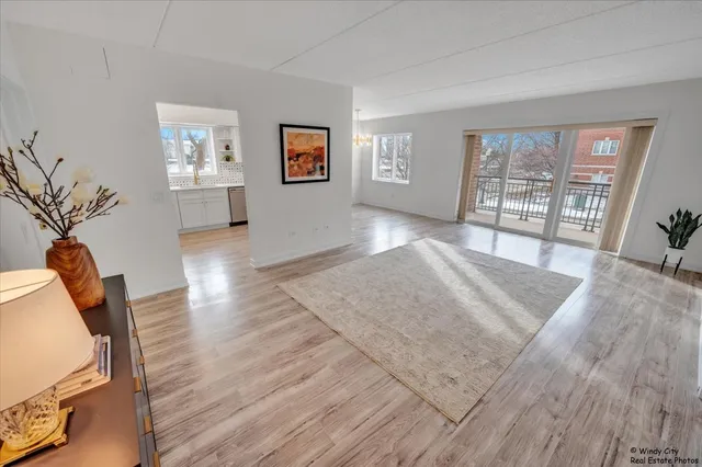 a view of a room with wooden floor and windows