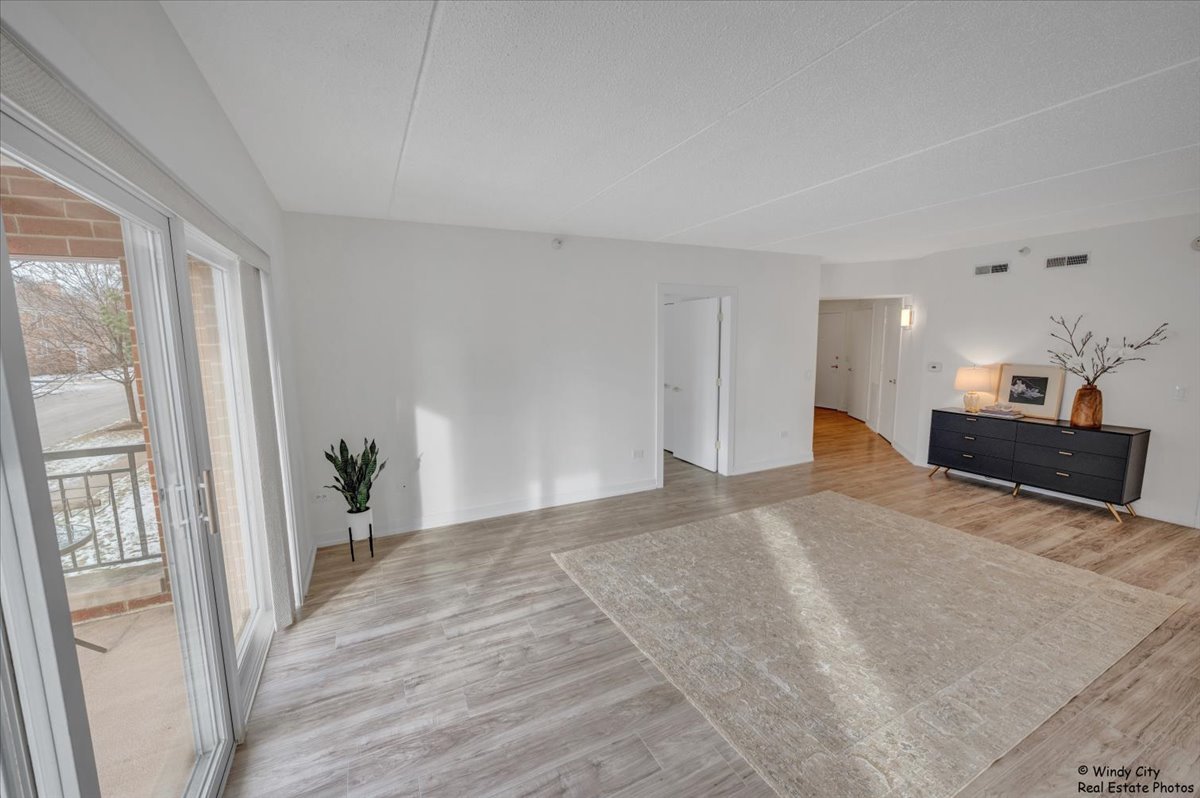 455 West Front Street, Unit 2208 Wheaton, IL 60187 - Photo 7 of 20 a view of a room with wooden floor and windows