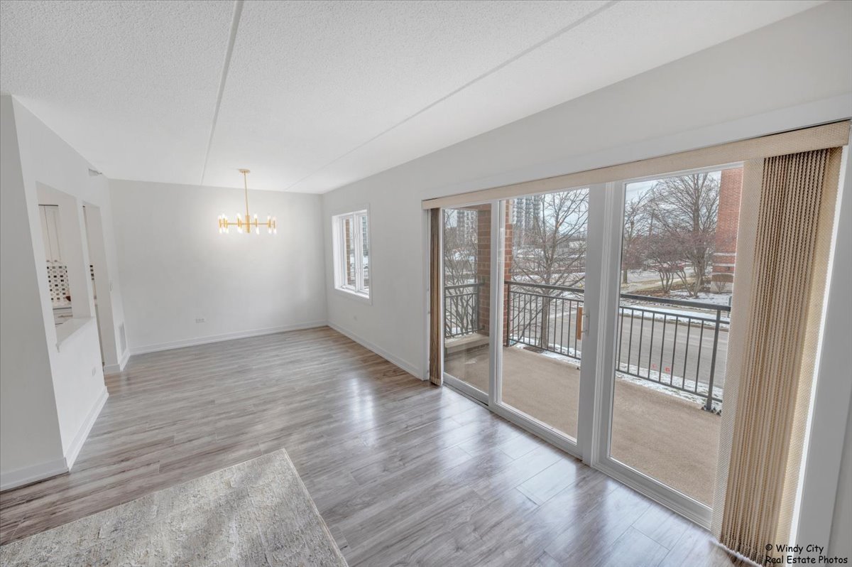 455 West Front Street, Unit 2208 Wheaton, IL 60187 - Photo 8 of 20 wooden floor in an empty room with a window