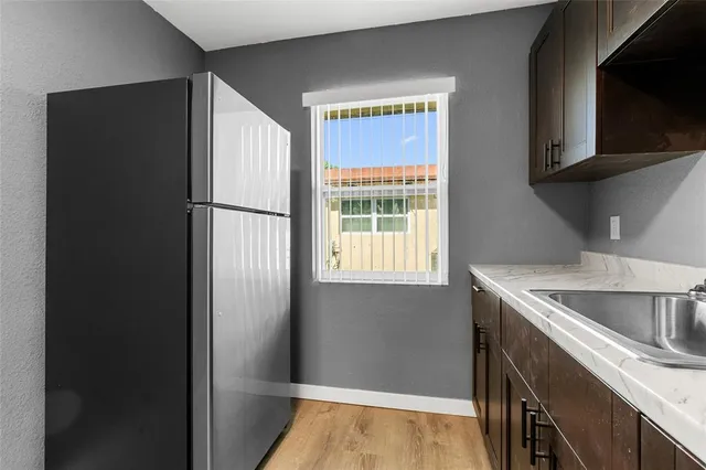 a kitchen with a refrigerator and a sink