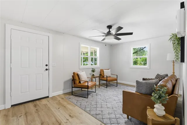 a living room with furniture and wooden floor