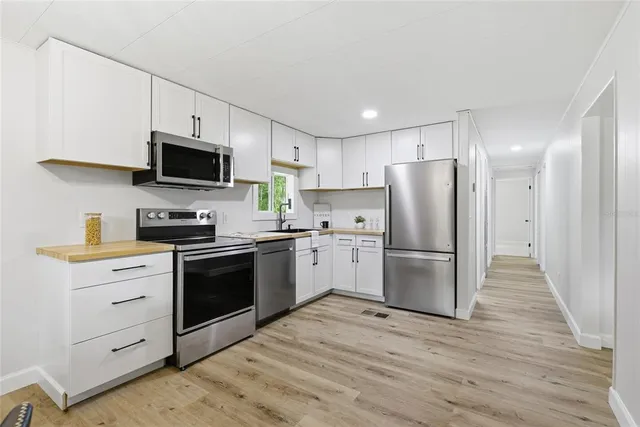 a kitchen with a refrigerator stove and a sink