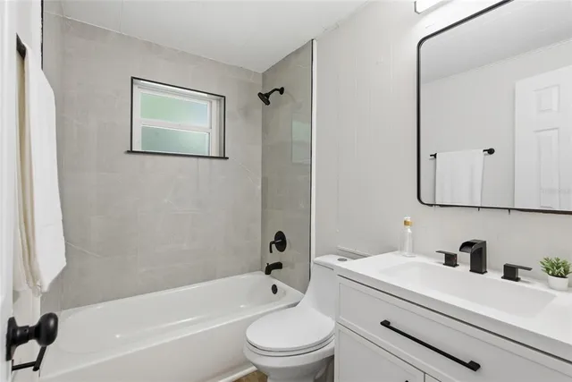 a bathroom with a sink a toilet and a bathtub