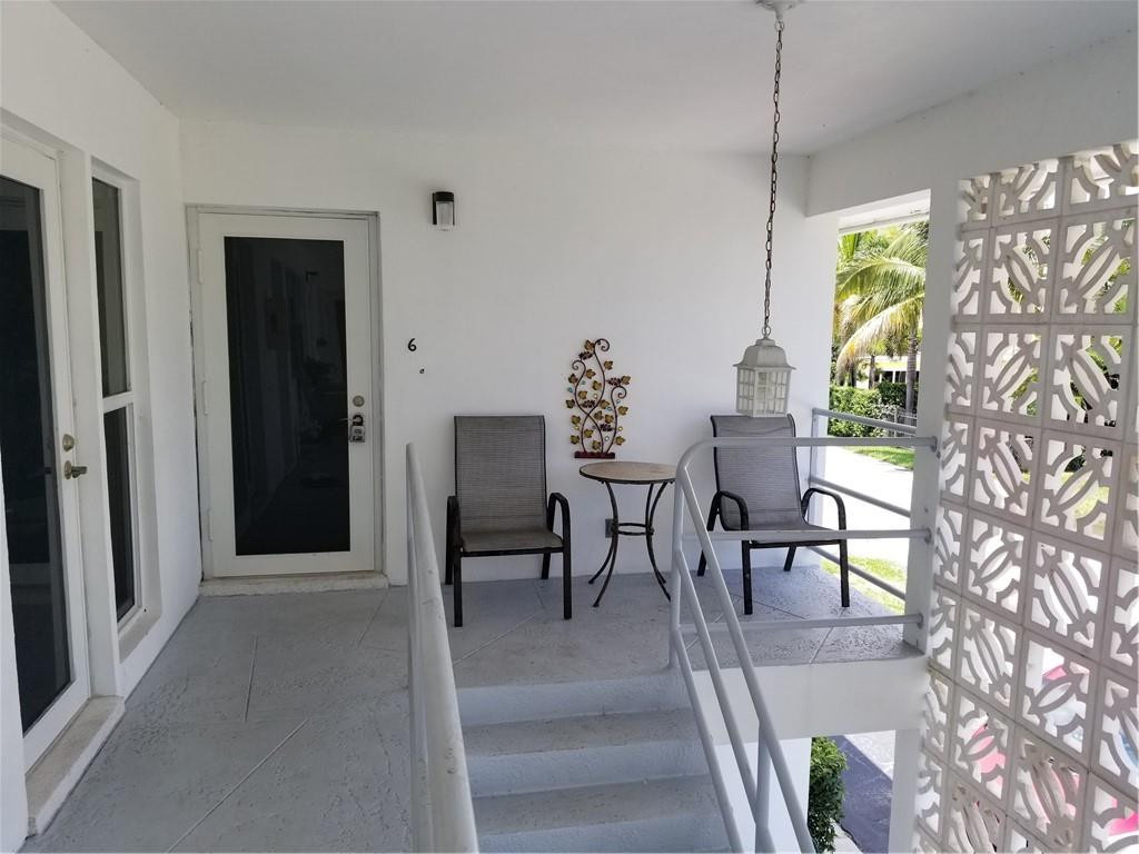 3208 Colony Club Road, Unit 6 Pompano Beach, FL 33062 - Photo 2 of 21 a view of a dining room with furniture a chandelier and a window
