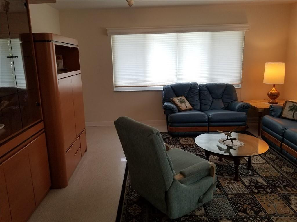 3208 Colony Club Road, Unit 6 Pompano Beach, FL 33062 - Photo 8 of 21 a living room with furniture a window and a wooden floor