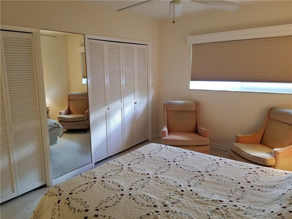3208 Colony Club Road, Unit 6 Pompano Beach, FL 33062 - Photo 10 of 21 a bedroom with a bed and a view of living room