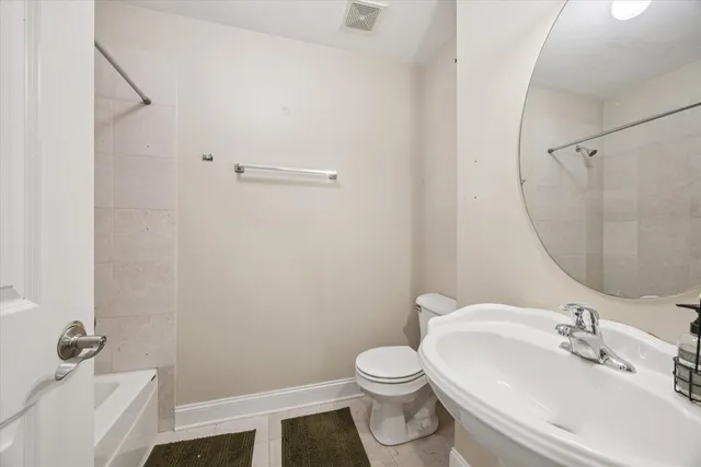 a bathroom with a sink toilet and a mirror