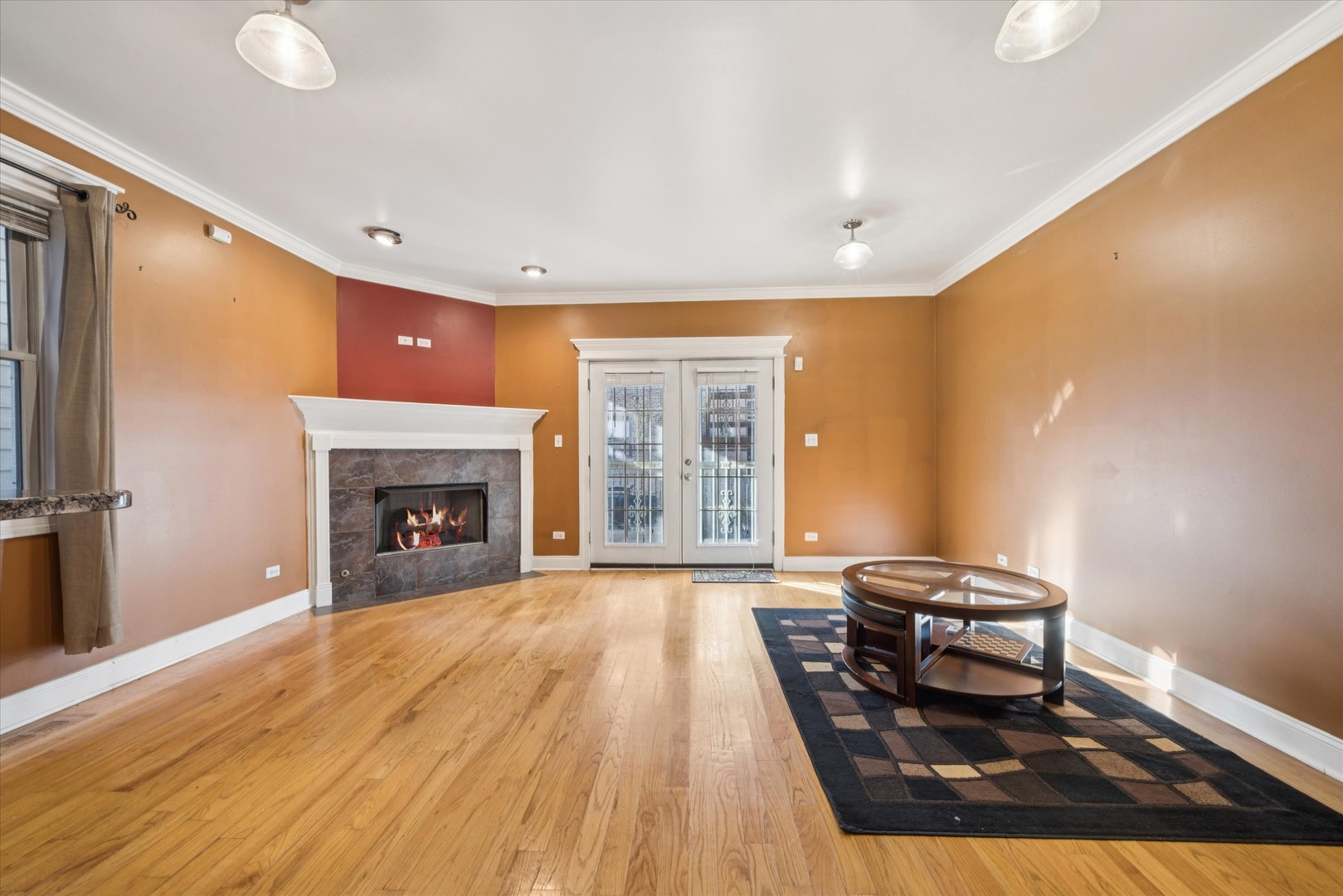 641 East 50th Street, Unit 1 Chicago, IL 60615 - Photo 2 of 15 a living room with a fireplace furniture and a floor to ceiling window