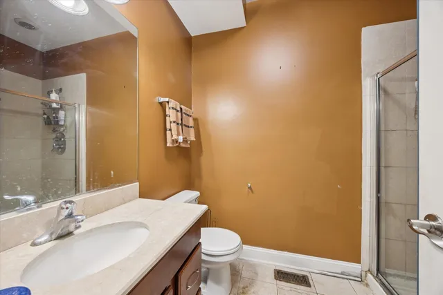 a bathroom with a sink a toilet and mirror