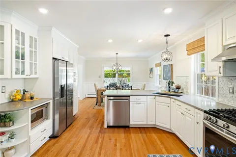 a kitchen with stainless steel appliances granite countertop a stove and a refrigerator