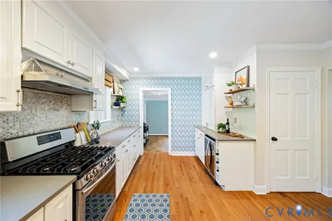 a kitchen with stainless steel appliances a stove a sink and a refrigerator