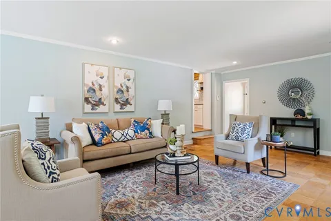 a living room with furniture a fireplace and a window