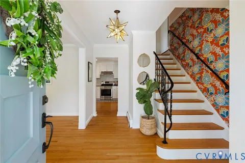 a view of entryway and hall with wooden floor