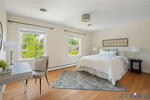 a bed room with a bed and a chair