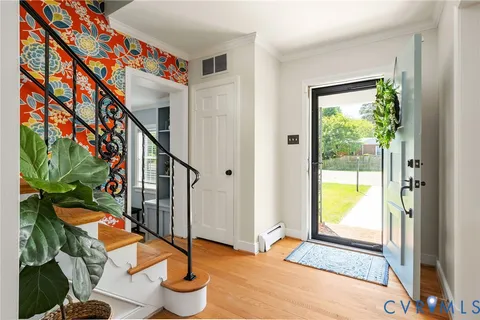 a view of entryway with wooden floor and front door