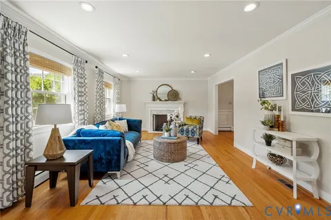 a living room with furniture a fireplace and a table