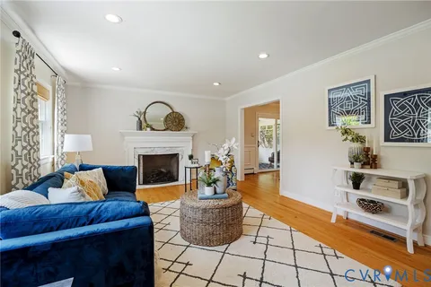 a living room with furniture and wooden floor