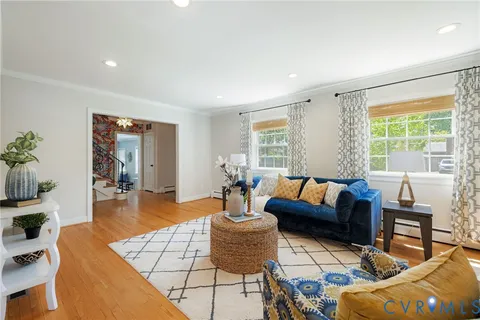 a living room with furniture and wooden floor