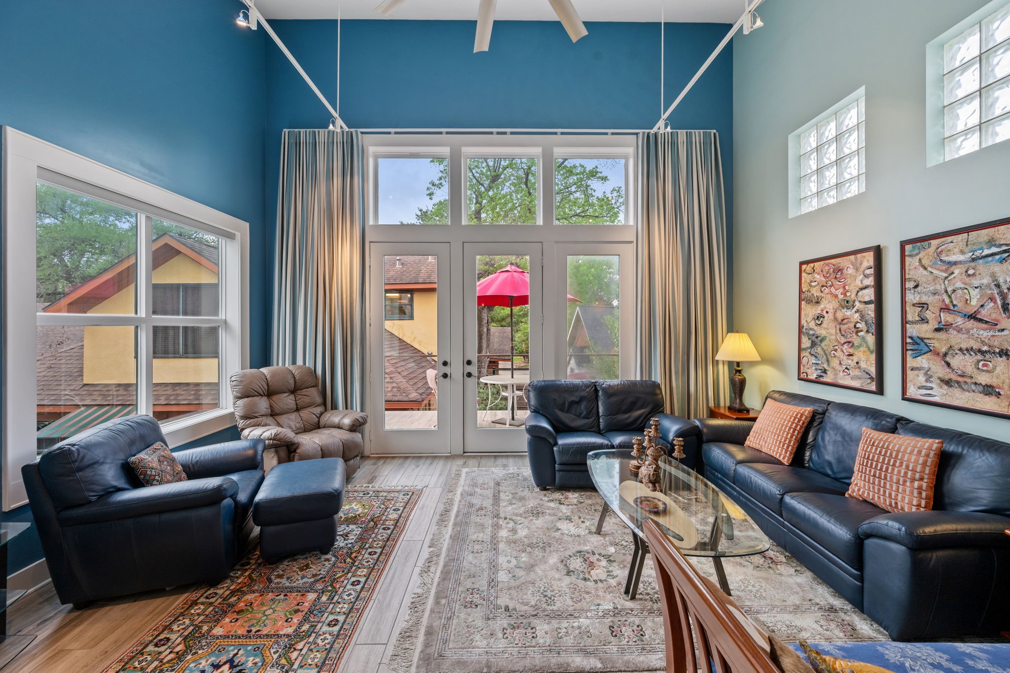 1911 Harold Street Houston, TX 77098 - Photo 24 of 36 The living room of the garage apartment offers a comfortable, light-filled space with access to an adjoining balcony overlooking the backyard and pool.