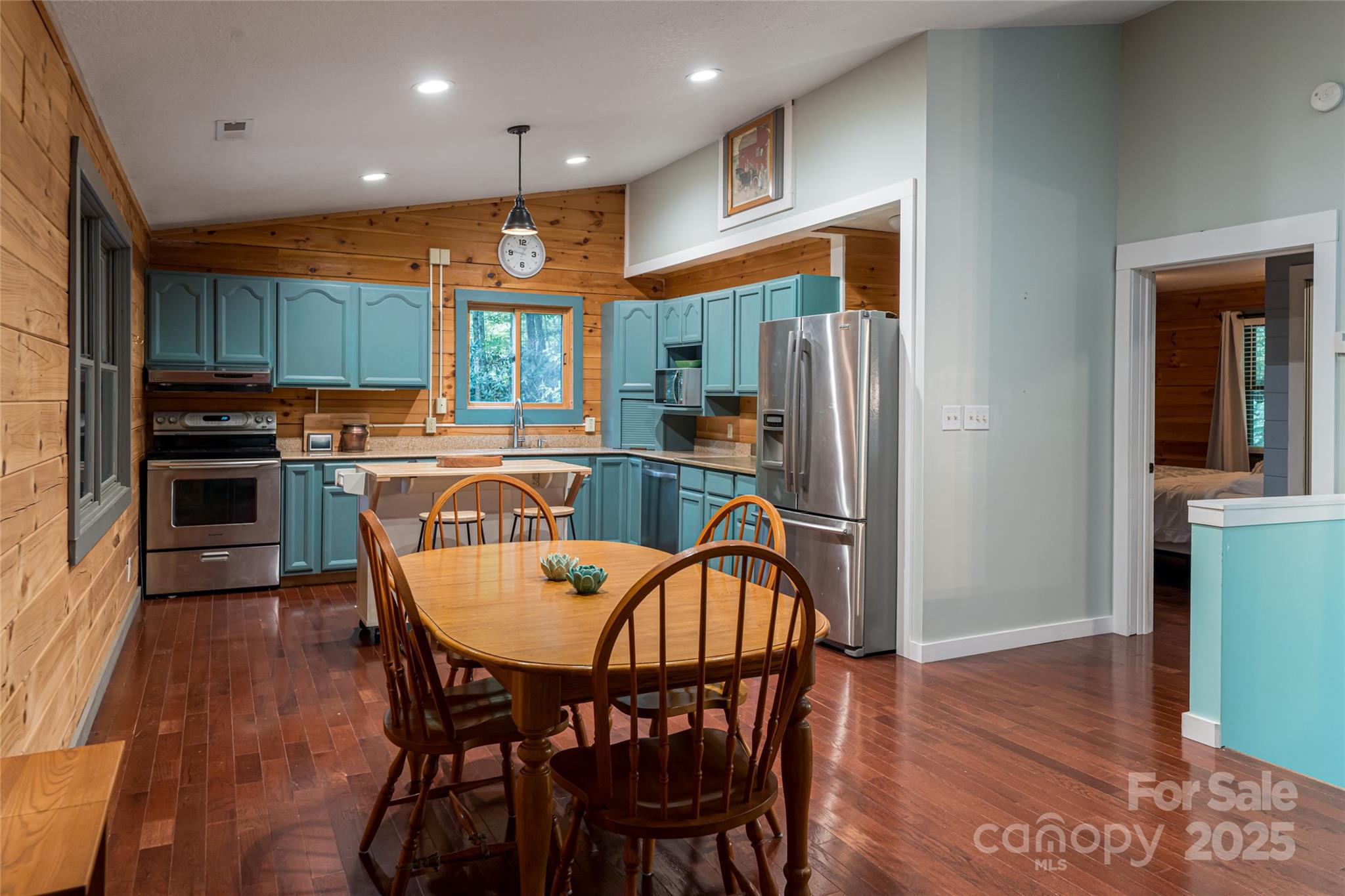 4035 Bald Creek Road Clyde, NC 28721 - Photo 11 of 42 a kitchen with stainless steel appliances granite countertop a dining table chairs refrigerator and sink