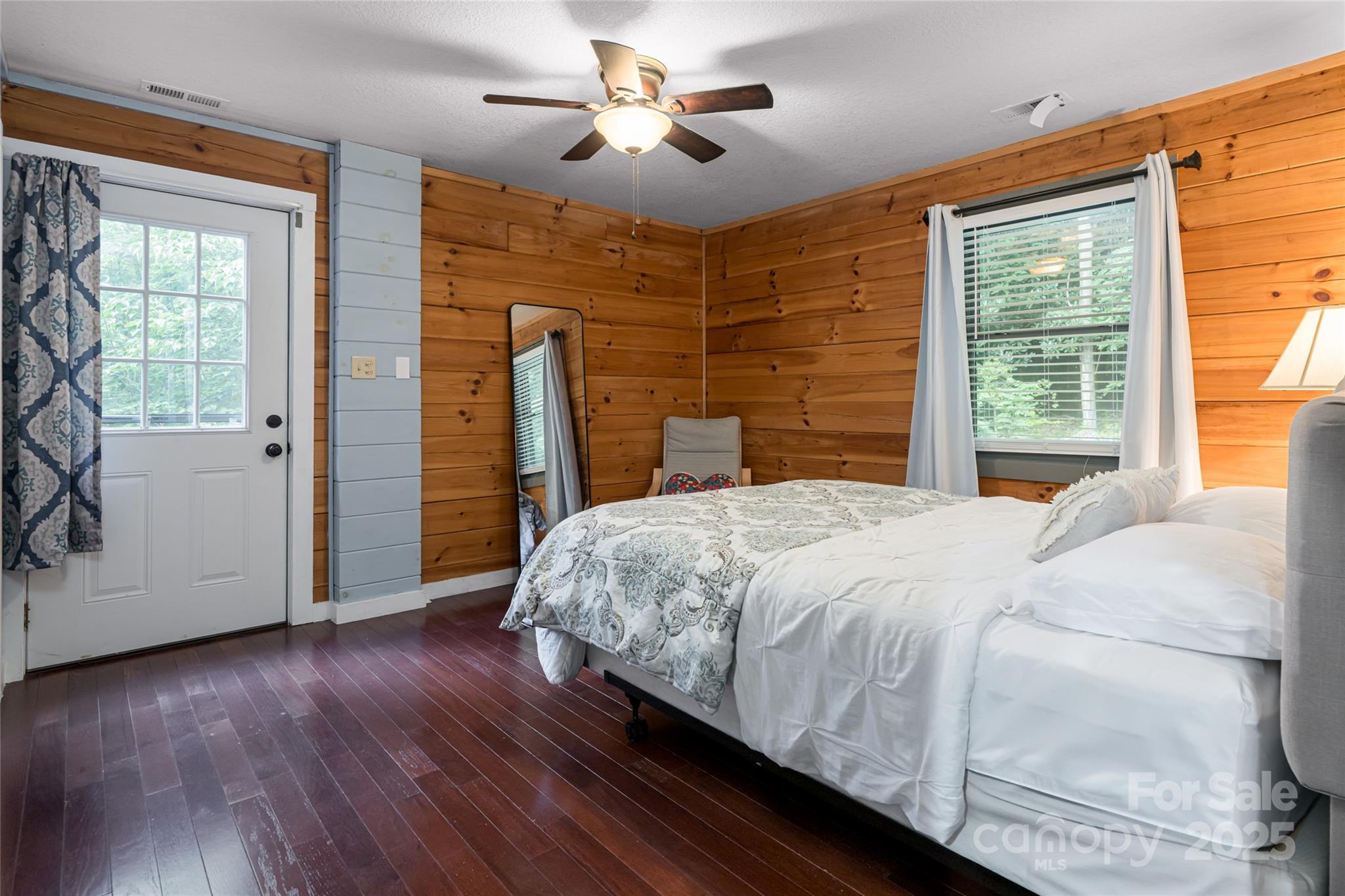 4035 Bald Creek Road Clyde, NC 28721 - Photo 15 of 42 a bedroom with a bed and a chandelier