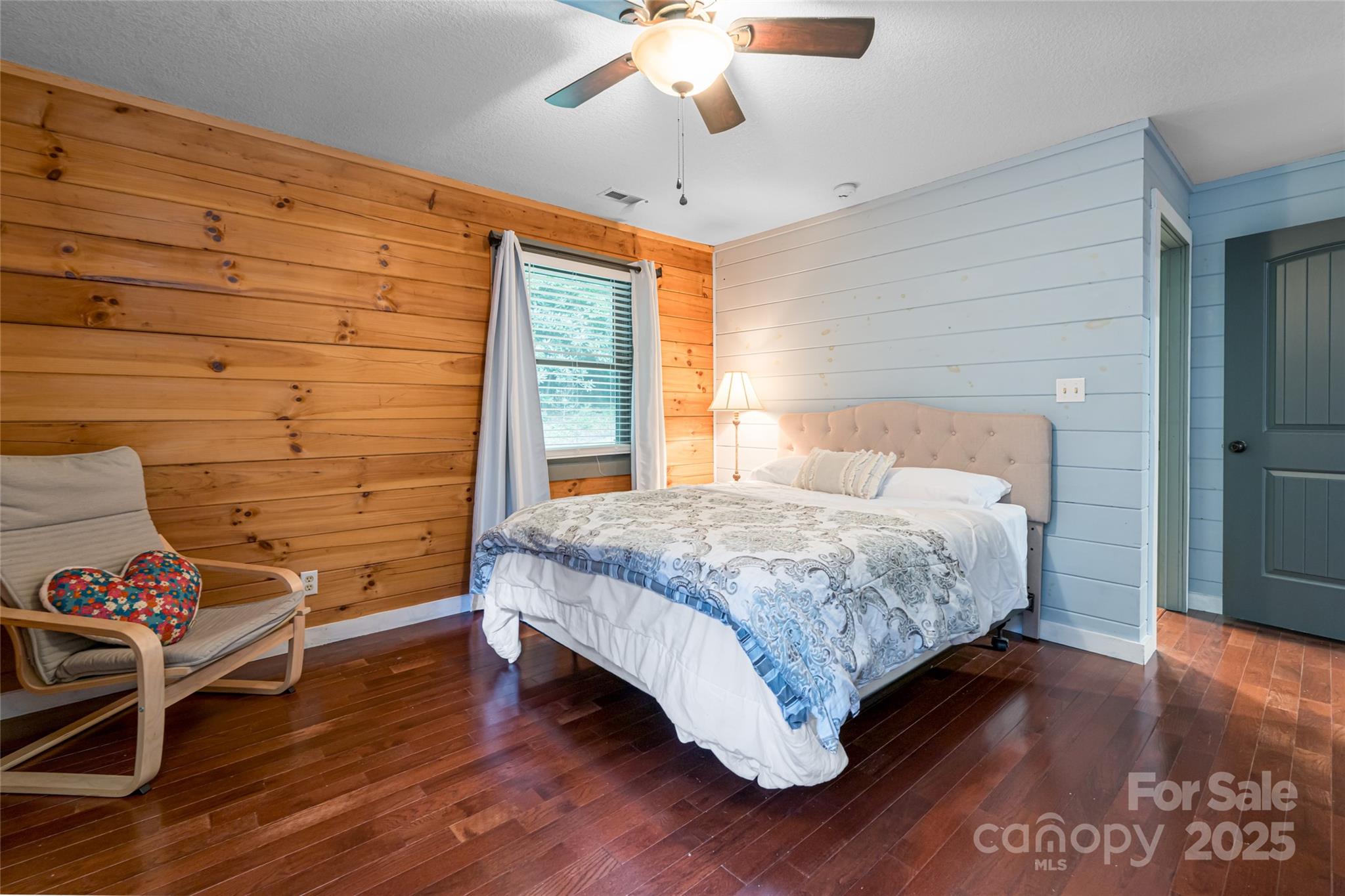 4035 Bald Creek Road Clyde, NC 28721 - Photo 16 of 42 a bedroom with a bed and a chandelier
