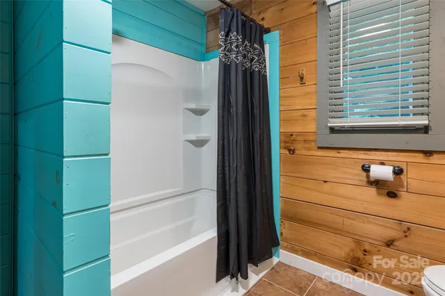 a bathroom with a shower and a sink