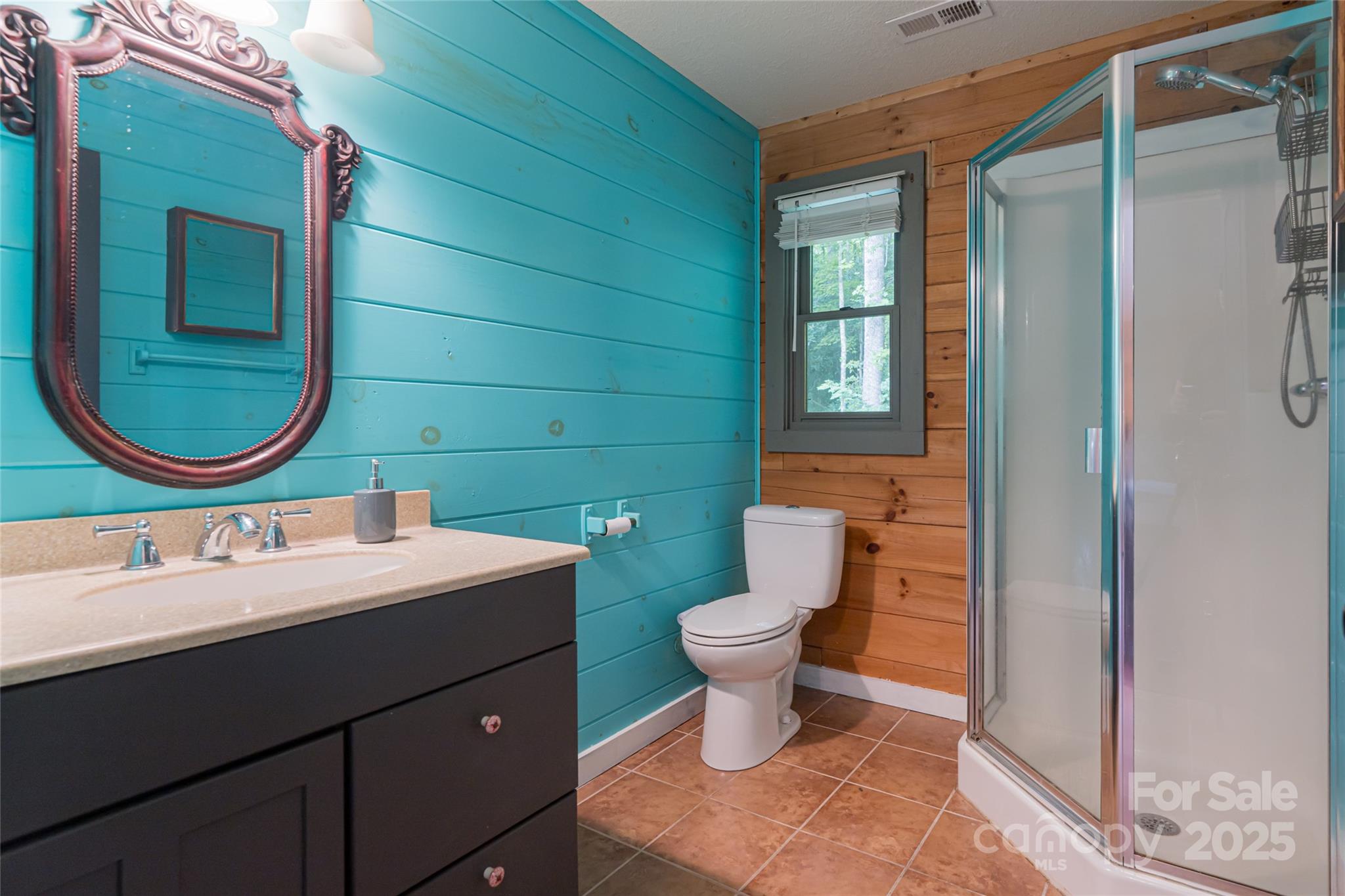 4035 Bald Creek Road Clyde, NC 28721 - Photo 20 of 42 a bathroom with a toilet sink and mirror