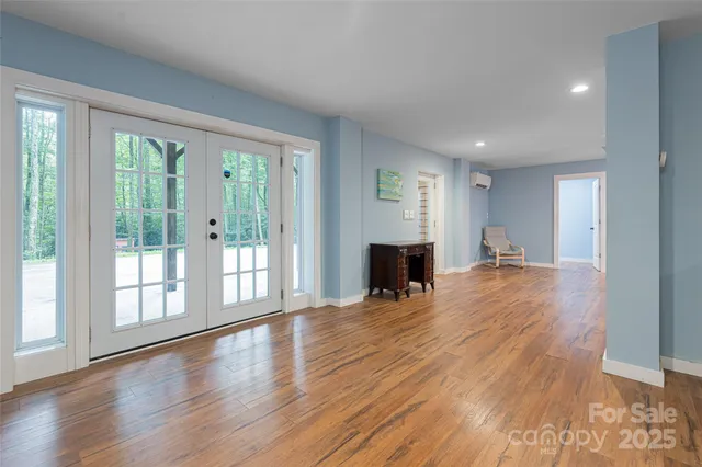 a view of empty room with wooden floor and fireplace