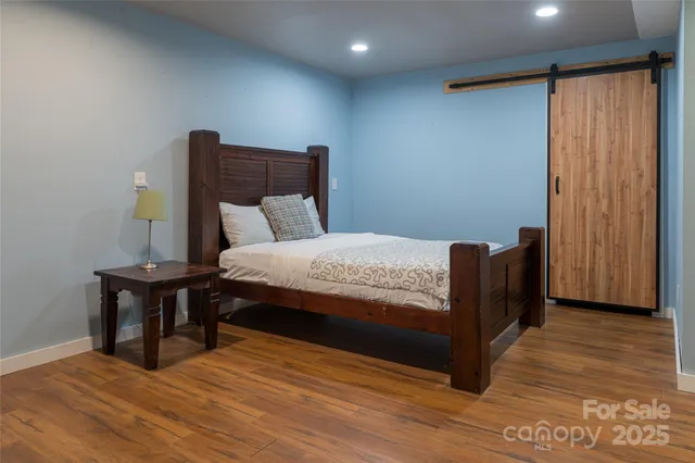 a view of a room with wooden floor and furniture