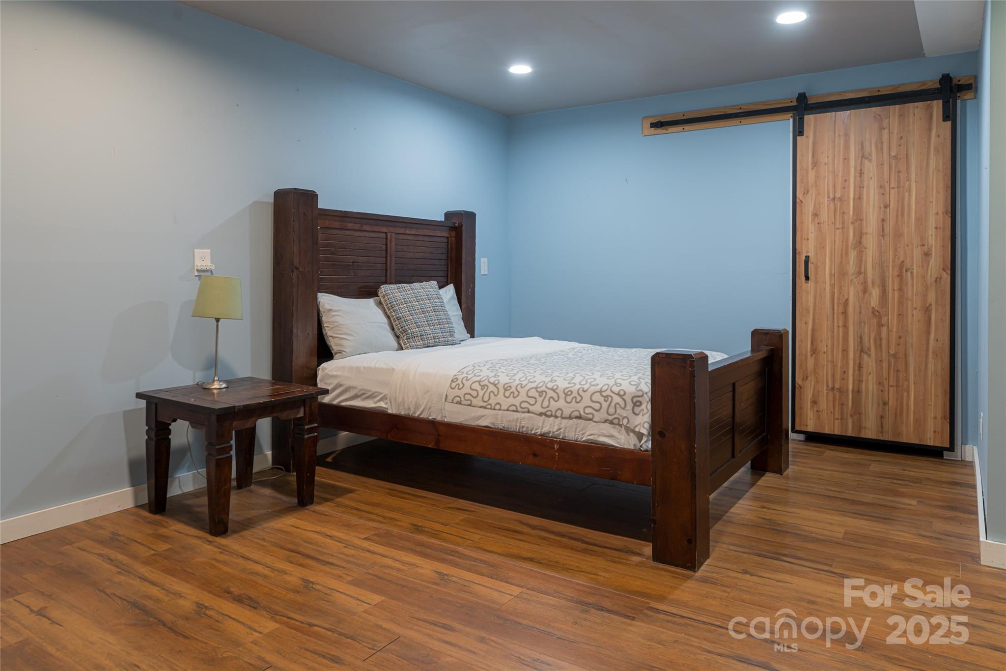 4035 Bald Creek Road Clyde, NC 28721 - Photo 28 of 42 a bedroom with a bed and wooden floor