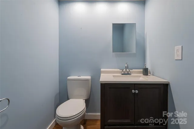 a room with stainless steel appliances lots of countertop furniture and a wooden floor