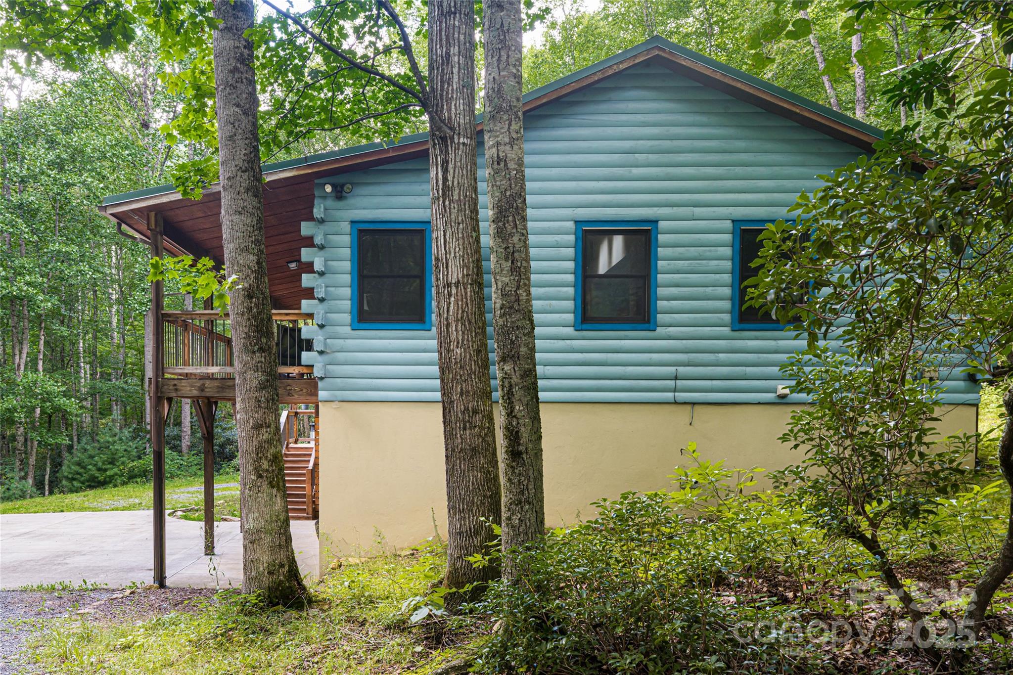 4035 Bald Creek Road Clyde, NC 28721 - Photo 35 of 42 a yellow house with trees in front of it