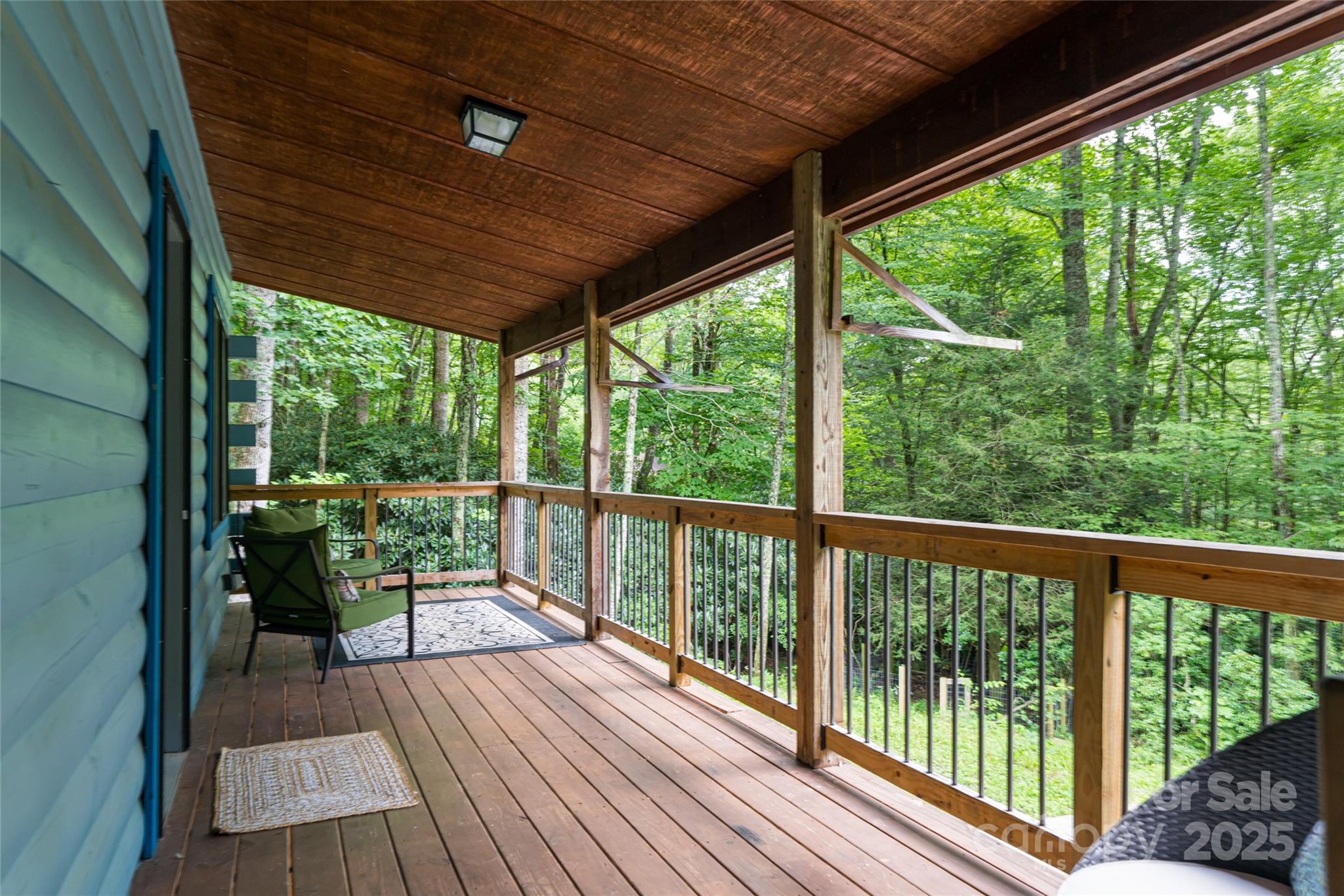 4035 Bald Creek Road Clyde, NC 28721 - Photo 4 of 42 a view of a balcony with chairs and wooden floor