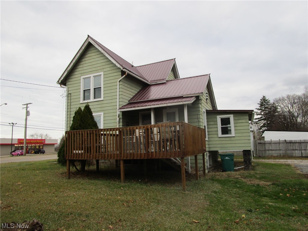 1938 East Prospect Road Ashtabula, OH 44004 - Photo 6 of 49 Back of house featuring a lawn and a deck