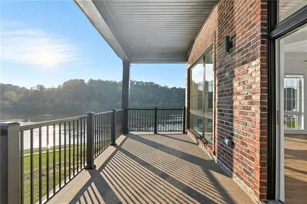 a balcony with view of trees in the background