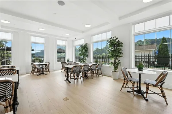 a dining room with furniture window and wooden floor