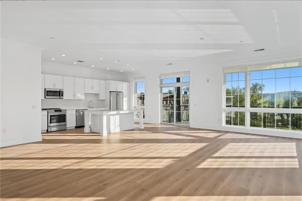 a view of a kitchen with kitchen island and living room
