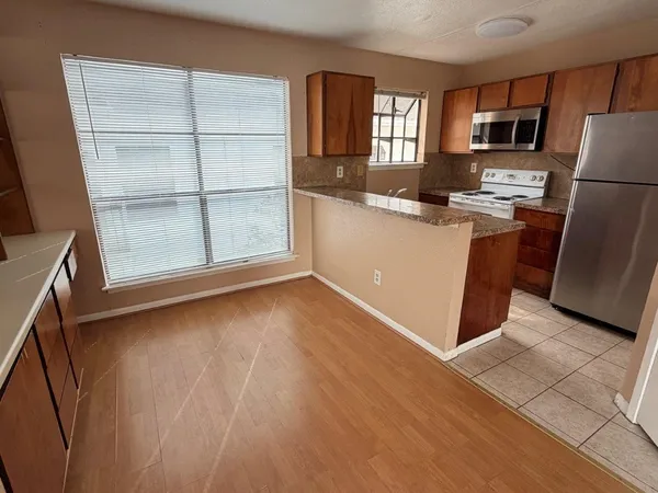 a kitchen with sink and refrigerator