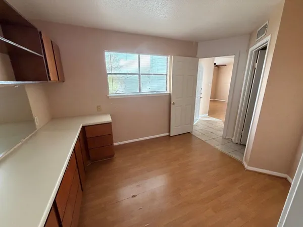 a view of room with window and refrigerator