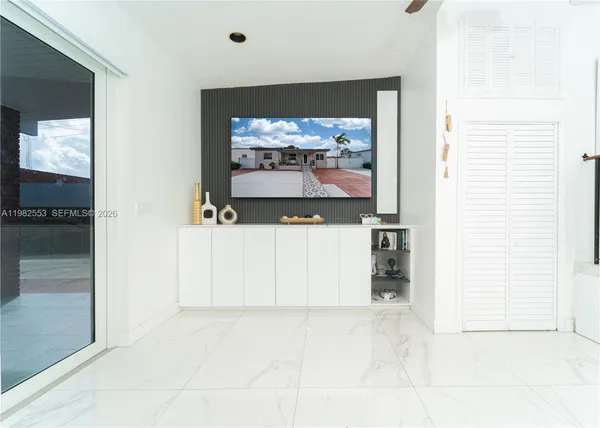 a living room with a fireplace and a flat screen tv