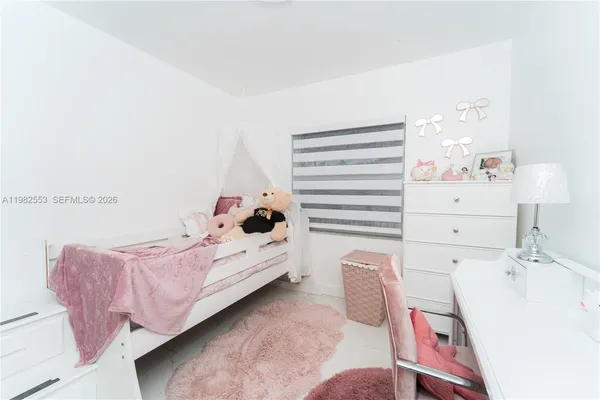 a bed room with a bed and a chair