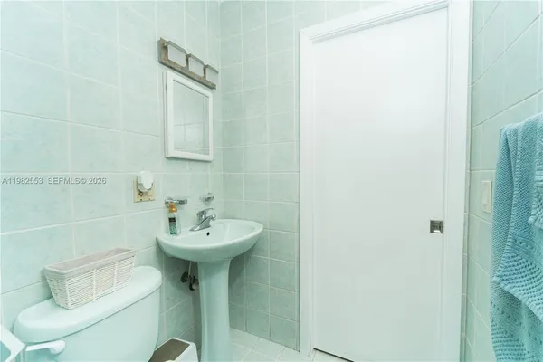 a bathroom with a sink a mirror and a shower