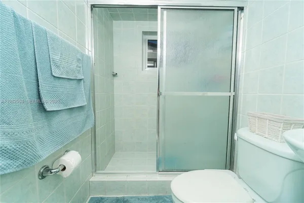 a bathroom with a toilet and a shower