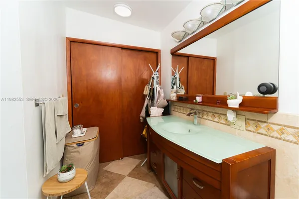 a bathroom with a sink mirror vanity and toilet